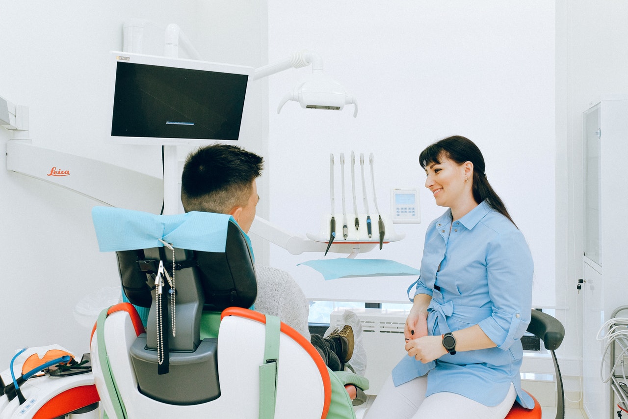 patient with dentist to ensure no gum disease develops