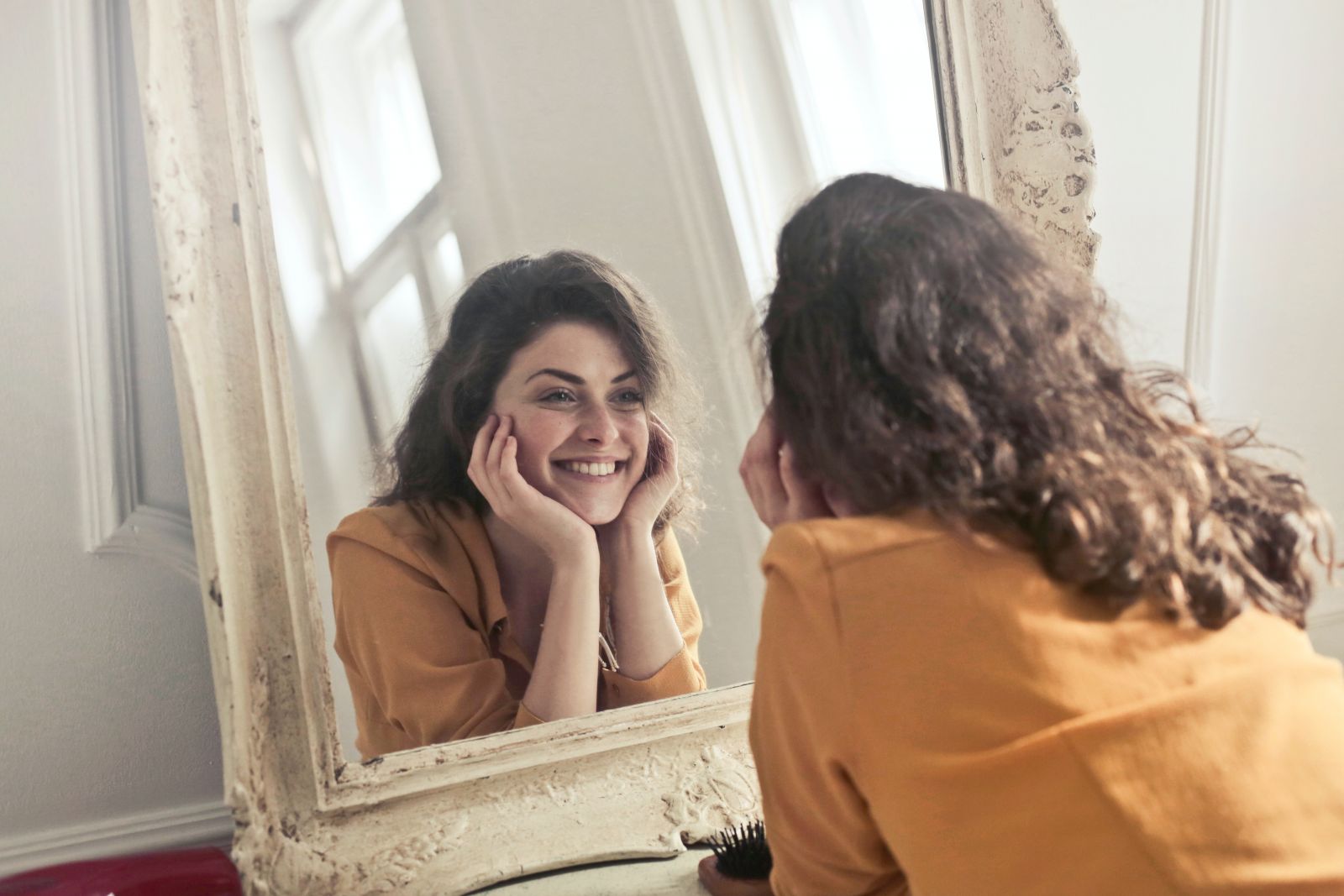 Women admiring her own bright white smile in mirror